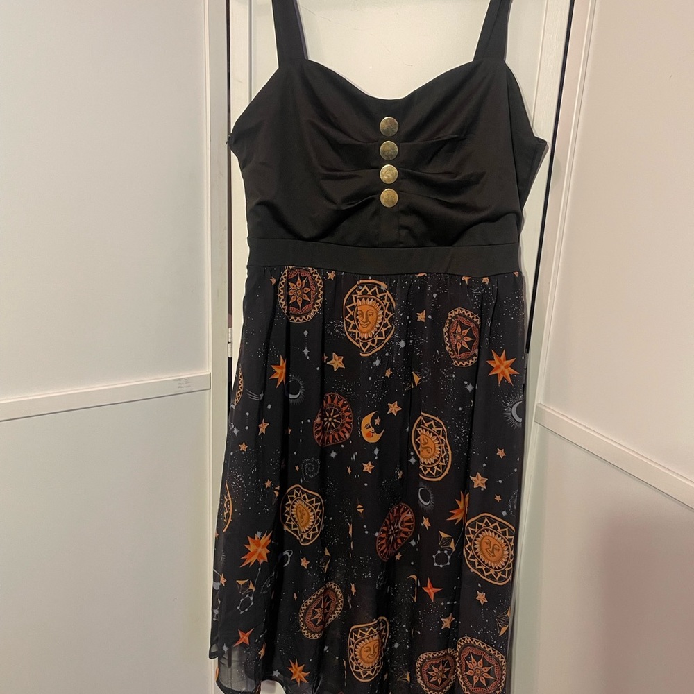 Fun and playful babydoll sheer overlay solar system themed dress.